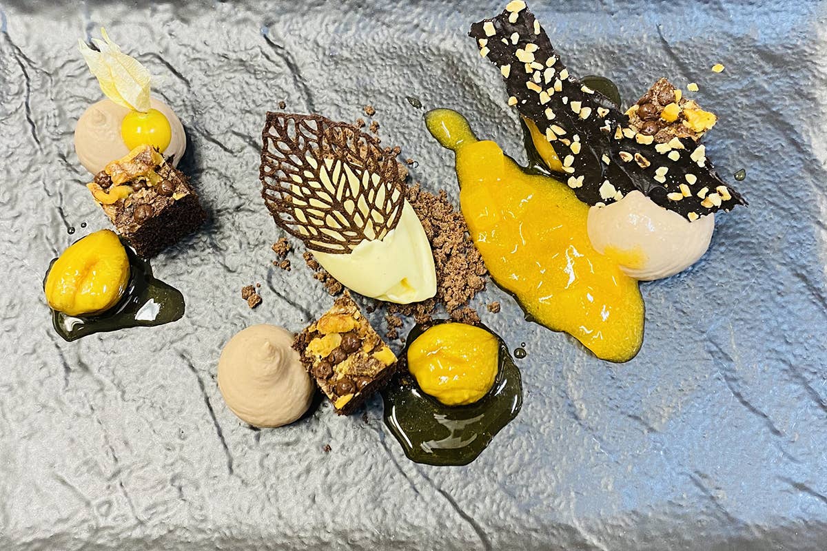 Karol Erlacher dell’Excelsior Dolomites Life Resort propone una Sinfonia di castagne, cachi e rhum Belvita Leading Wellnesshotels, in Alto Adige food experience e giovani cuochi